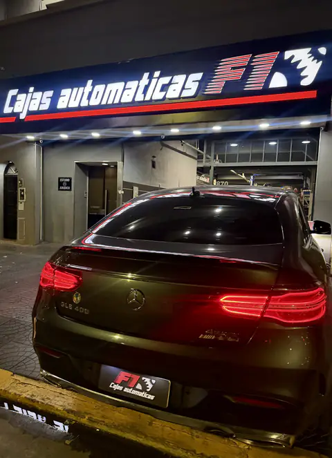 Mercedes-Benz GLE 400 de noche frente a la fachada iluminada de Cajas Automáticas F1