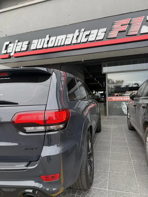 Jeep SRT gris estacionado junto a la entrada del local de Cajas Automáticas F1