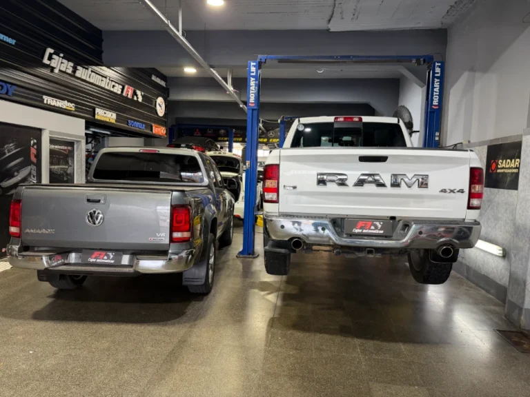 Pickups Volkswagen Amarok y RAM sobre elevadores en el taller F1